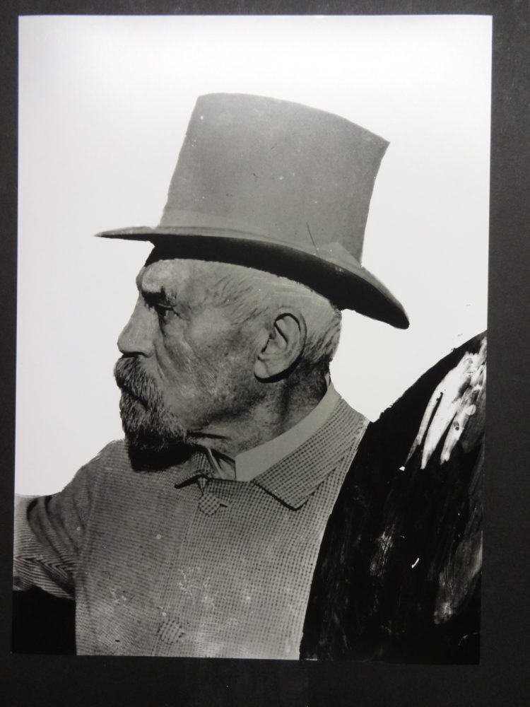 Sir Richard Burton wearing a top hat with background coloured red