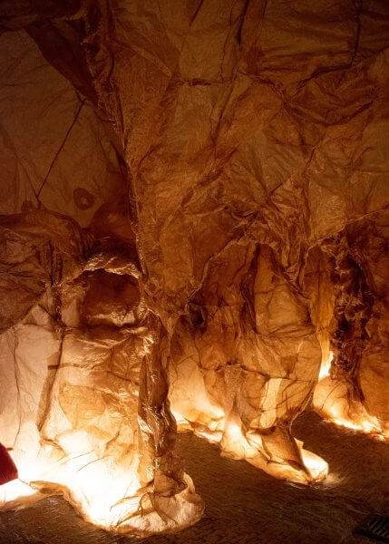 Detail of the Templum, showing the brown paper walls over a wire frame and lighting on the floor.