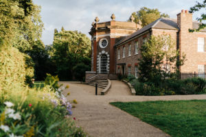 Orleans House Gallery, a historic brick building surrounded by gardens and trees